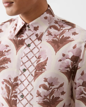 Load image into Gallery viewer, Close-up of a patterned shirt with floral and geometric designs.